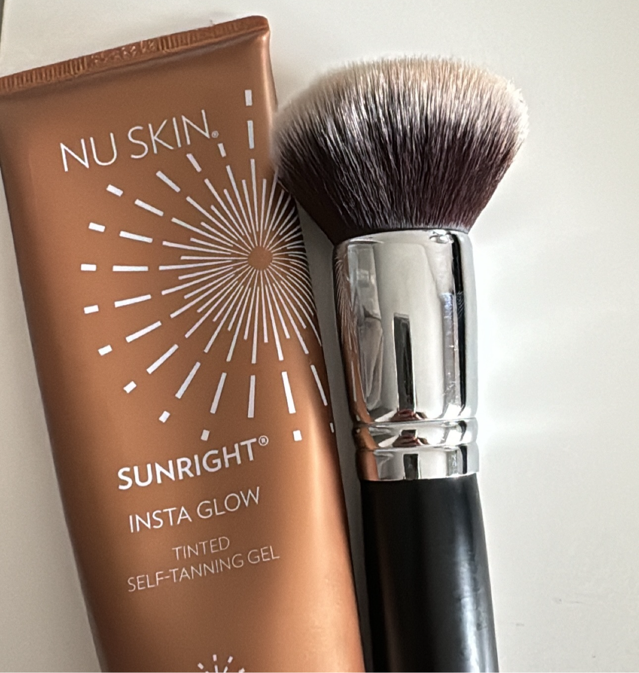 Apply Nu Skin Insta Glow for a natural tan on face and body