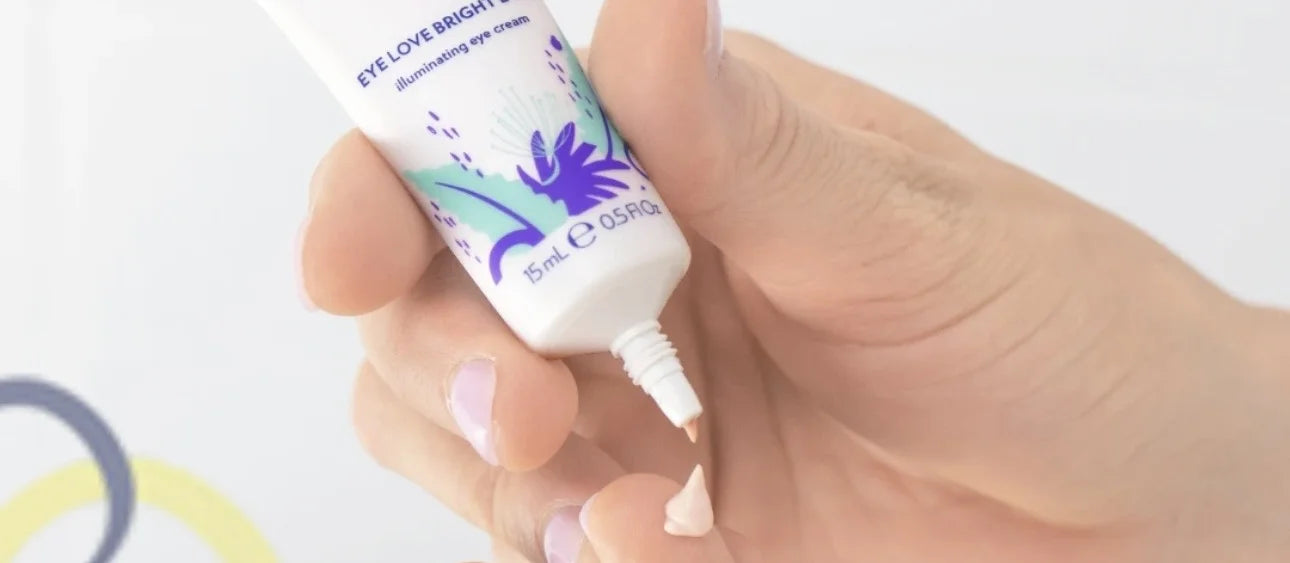 Applying Eye Love Bright Eyes eye cream with a fingertip around the eye area